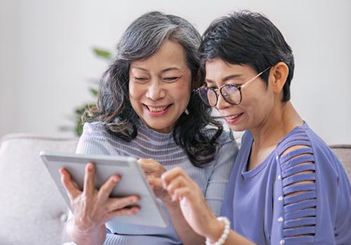 Two old woman using a tablet