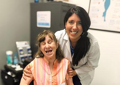 Daniela with a patient in hearing office